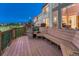 This outdoor deck features integrated bench seating and overlooks a lush green space at twilight at 12350 Turquoise Terrace St, Castle Pines, CO 80108