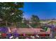 Wooden deck featuring a built-in flower box with vibrant flowers and views of the surrounding greenery at 12350 Turquoise Terrace St, Castle Pines, CO 80108