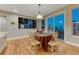 Dining room featuring a sliding glass door, wood floors, and large windows at 12350 Turquoise Terrace St, Castle Pines, CO 80108