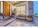 Inviting front porch featuring a wooden door, stone accents, and a bench with decorative potted plants at 12350 Turquoise Terrace St, Castle Pines, CO 80108