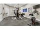 Home gym equipped with weight machines, stationary bike, rubber flooring, and a mounted TV at 12350 Turquoise Terrace St, Castle Pines, CO 80108