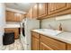 Functional laundry room featuring a washer, dryer, utility sink, and ample cabinet space at 12350 Turquoise Terrace St, Castle Pines, CO 80108