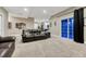 Basement living room featuring dark leather sofas, TV, walkout to a patio, and adjacent gym area at 12350 Turquoise Terrace St, Castle Pines, CO 80108