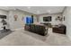 Basement living room featuring a large dark leather sofa, TV, walkout to a patio, and adjacent gym area at 12350 Turquoise Terrace St, Castle Pines, CO 80108