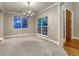 Bright living room with large windows, carpet flooring, and an elegant chandelier at 12350 Turquoise Terrace St, Castle Pines, CO 80108