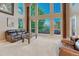 Living room with soaring ceilings, large windows offering scenic views, and comfortable leather seating at 12350 Turquoise Terrace St, Castle Pines, CO 80108