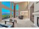 Spacious living room with a fireplace, large windows offering scenic views, and plush carpet at 12350 Turquoise Terrace St, Castle Pines, CO 80108