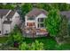Aerial view of a home with a large deck, mature trees, and a well-maintained yard at 12350 Turquoise Terrace St, Castle Pines, CO 80108