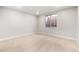 Empty basement with carpet flooring, egress window, and neutral paint at 6529 Still Pine Cir, Castle Pines, CO 80108
