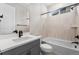 Well-lit bathroom featuring a tub and shower, modern vanity, and neutral tiling at 6529 Still Pine Cir, Castle Pines, CO 80108