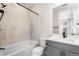 Well-lit bathroom featuring a tub and shower, modern vanity, and neutral tiling at 6529 Still Pine Cir, Castle Pines, CO 80108