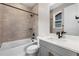 Well-lit bathroom featuring a tub and shower, modern vanity, and earth-tone tiling at 6529 Still Pine Cir, Castle Pines, CO 80108