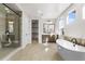 Bright and airy bathroom with modern fixtures, a soaking tub, and a separate glass shower at 6529 Still Pine Cir, Castle Pines, CO 80108