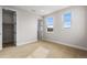 Neutral carpeted bedroom featuring bright windows and a closet at 6529 Still Pine Cir, Castle Pines, CO 80108