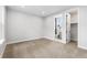 Neutral carpeted bedroom featuring an ensuite bathroom and walk-in closet at 6529 Still Pine Cir, Castle Pines, CO 80108