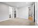 Neutral carpeted bedroom featuring an ensuite bathroom, and walk-in closet at 6529 Still Pine Cir, Castle Pines, CO 80108