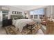 Comfortable bedroom featuring a large window, stylish rug, and neutral decor at 6529 Still Pine Cir, Castle Pines, CO 80108
