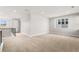 Spacious bonus room with neutral carpet and ample natural light from the large window at 6529 Still Pine Cir, Castle Pines, CO 80108