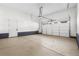 Clean and spacious two car garage with painted floor, garage door and service door at 6529 Still Pine Cir, Castle Pines, CO 80108