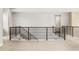 Hallway with modern black metal railing leading to the next level of the home at 6529 Still Pine Cir, Castle Pines, CO 80108