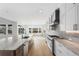 Spacious kitchen featuring stone countertops, stainless appliances, and large windows at 6529 Still Pine Cir, Castle Pines, CO 80108
