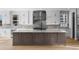 Bright kitchen features an island, white cabinets, and stainless steel appliances at 6529 Still Pine Cir, Castle Pines, CO 80108