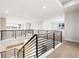Upstairs landing featuring modern railing, an open layout, and plenty of natural light at 6529 Still Pine Cir, Castle Pines, CO 80108