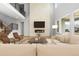 Bright living room with fireplace, comfortable seating, and view of the yard at 6529 Still Pine Cir, Castle Pines, CO 80108