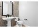 Stylish powder room featuring a modern vanity, toilet, and elegant tile accents at 6529 Still Pine Cir, Castle Pines, CO 80108