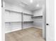 A large walk-in closet with shelving, rods, and carpet at 6529 Still Pine Cir, Castle Pines, CO 80108