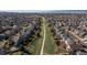 A serene aerial view of a residential area, featuring a pathway meandering through a lush green space at 1018 Mulberry Ln, Highlands Ranch, CO 80129