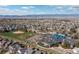 Aerial view showcasing the neighborhood with nearby school, baseball field, playground, and scenic mountain backdrop at 1018 Mulberry Ln, Highlands Ranch, CO 80129