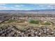 An aerial view captures the expansive community landscape, featuring green spaces, sports fields, and distant mountains at 1018 Mulberry Ln, Highlands Ranch, CO 80129