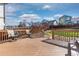 Wooden deck with outdoor seating overlooking backyard with grass, landscaping, and a well-maintained wooden fence at 1018 Mulberry Ln, Highlands Ranch, CO 80129