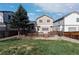 Well-maintained backyard featuring a wooden deck, a lush green lawn, and mature tree providing shade at 1018 Mulberry Ln, Highlands Ranch, CO 80129