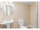 Powder room with pedestal sink, a low-flow toilet, and a walk-in shower featuring a white door at 1018 Mulberry Ln, Highlands Ranch, CO 80129