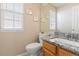 Charming half bathroom featuring granite countertops, ample natural light, and a decorative seashell theme at 1018 Mulberry Ln, Highlands Ranch, CO 80129