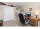 Bright bedroom showcasing a work area with a wooden desk, and a comfortable black chair with white trim at 1018 Mulberry Ln, Highlands Ranch, CO 80129