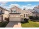 Charming two-story home with a well-manicured lawn and attached two-car garage at 1018 Mulberry Ln, Highlands Ranch, CO 80129