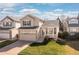 Charming two-story home featuring a well-manicured front lawn, a two-car garage, and lovely bay window at 1018 Mulberry Ln, Highlands Ranch, CO 80129