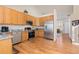 Kitchen featuring wooden cabinets, stainless steel appliances, and easy access to dining at 1018 Mulberry Ln, Highlands Ranch, CO 80129