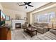 Inviting living room with a fireplace, plush seating, and a ceiling fan at 1018 Mulberry Ln, Highlands Ranch, CO 80129