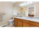 Well-lit main bathroom with double sinks, granite countertops, and a glass-enclosed shower at 1018 Mulberry Ln, Highlands Ranch, CO 80129