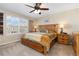 Serene main bedroom showcasing a large window, ceiling fan, and comfortable wooden bed frame and side tables at 1018 Mulberry Ln, Highlands Ranch, CO 80129