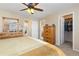 Bright main bedroom with a walk-in closet, dresser, and an ensuite bathroom and office space at 1018 Mulberry Ln, Highlands Ranch, CO 80129