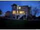 Backyard featuring a deck and outdoor grill area illuminated at dusk at 7692 Weaver Cir, Castle Rock, CO 80104