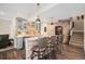 Home bar with seating for four, granite countertops, pendant lighting, and custom cabinetry at 7692 Weaver Cir, Castle Rock, CO 80104