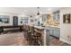 Home bar with seating for five, granite countertops, pendant lighting, and custom cabinetry at 7692 Weaver Cir, Castle Rock, CO 80104