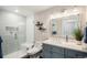 Tastefully updated bathroom with a glass enclosed shower, quartz countertop and a framed vanity mirror at 7692 Weaver Cir, Castle Rock, CO 80104