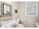 Clean powder room with pedestal sink and decorative mirror at 7692 Weaver Cir, Castle Rock, CO 80104